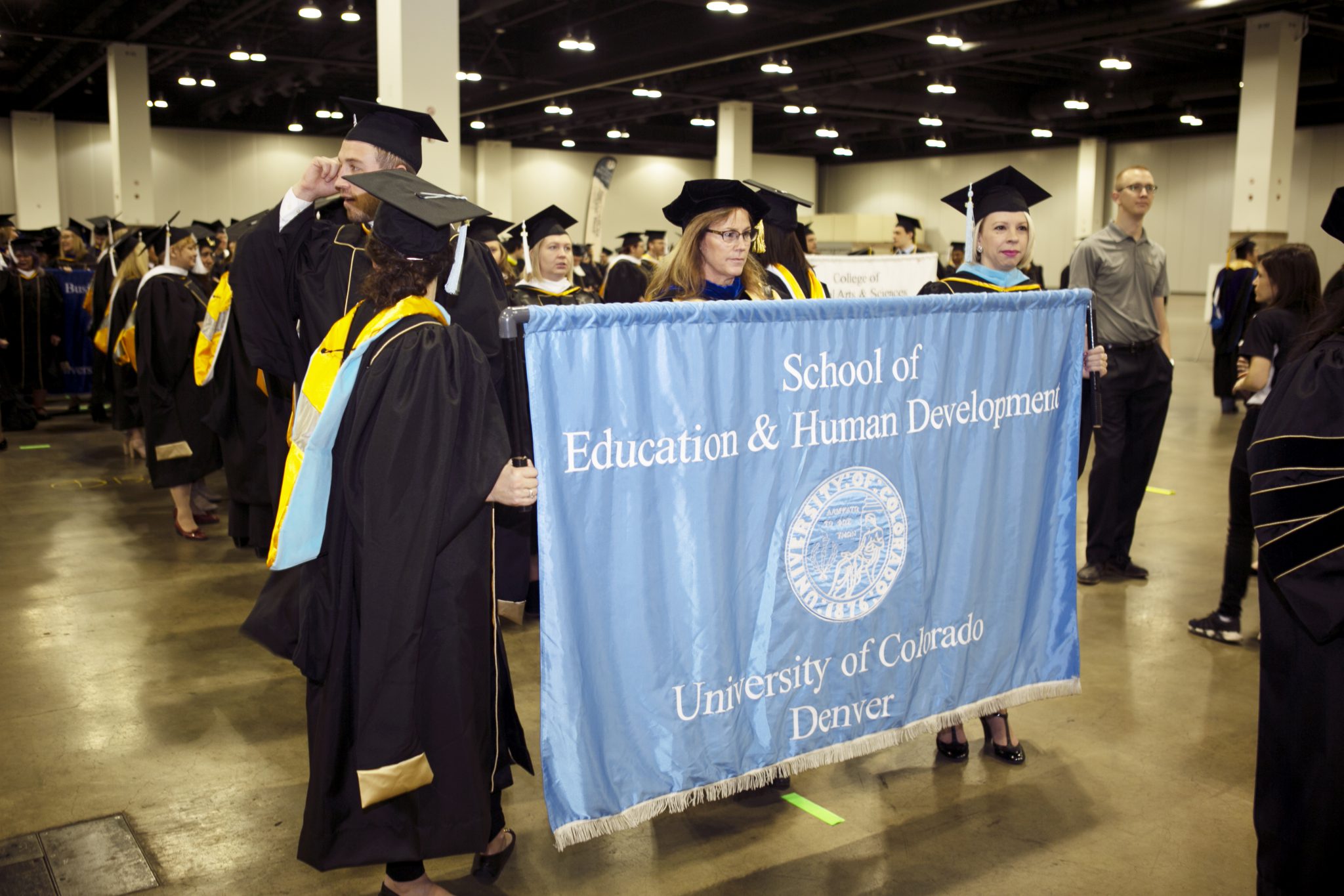 Image of SEHD grad banner being held during Fall Commencement