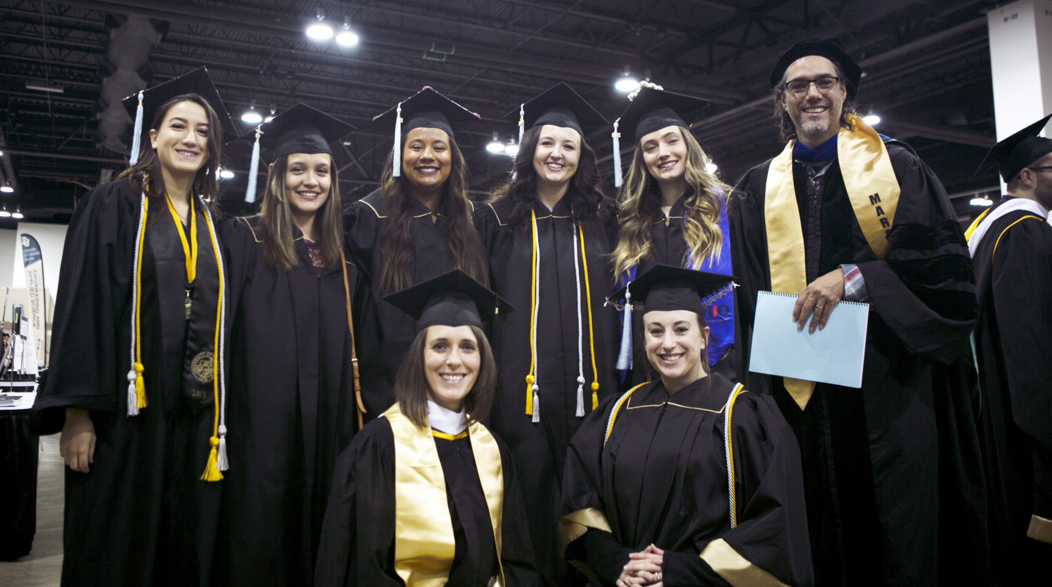 Image of eight HDFR cohort students and faulty at fall commencement
