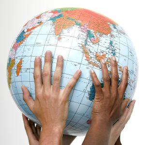 Kids with hands on a globe